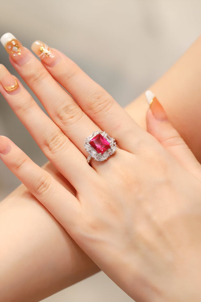 Close-up of a woman's hand adorned with a striking ruby ring, captured in Dubai.